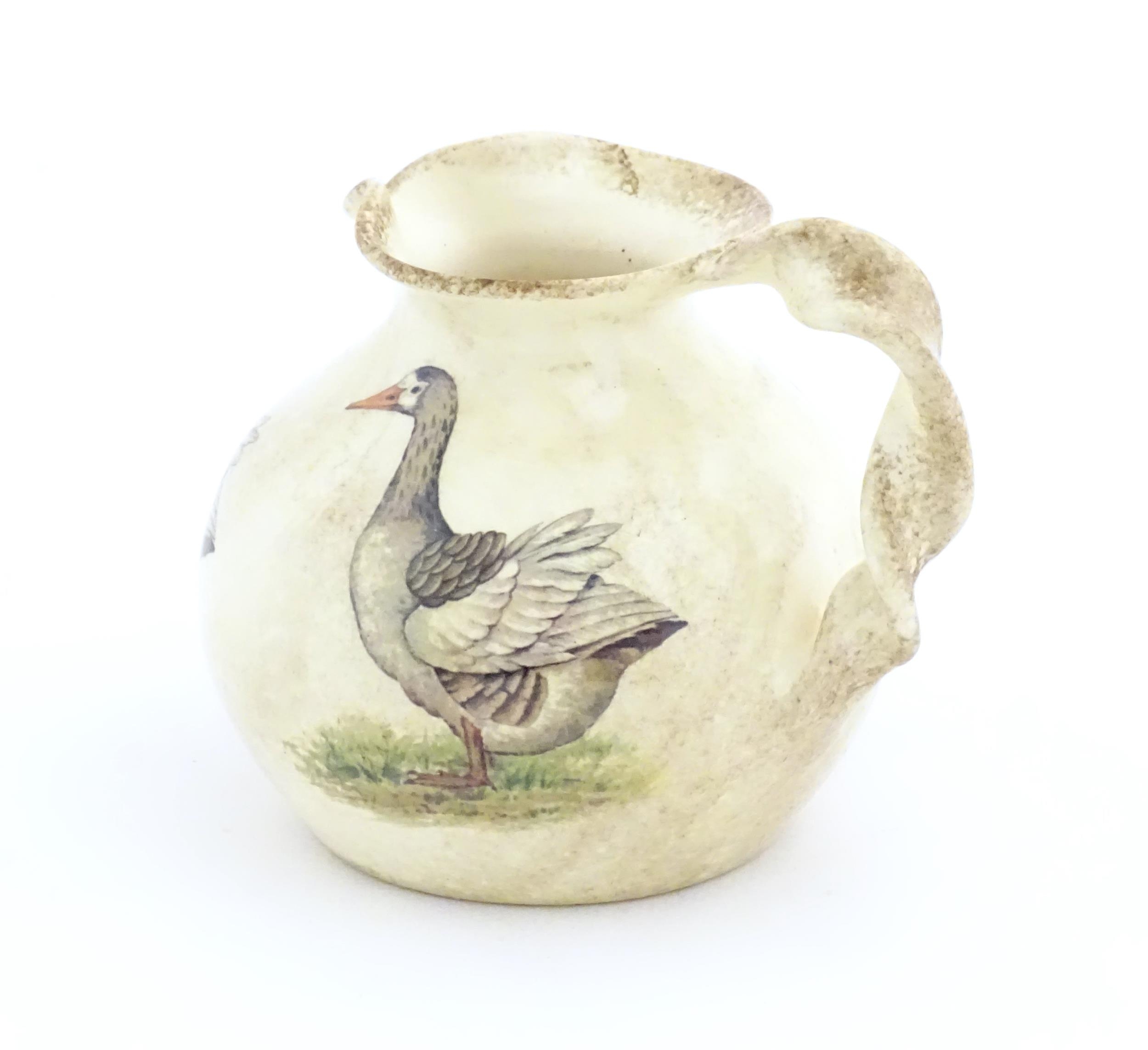 A Yorkshire Moorlands pottery jug with twist handle decorated with geese. Marked under. Approx. 4 - Image 4 of 8