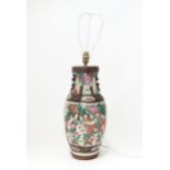 A table lamp formed from a an Oriental vase decorated with figures and horses. Approx 20" (inc.