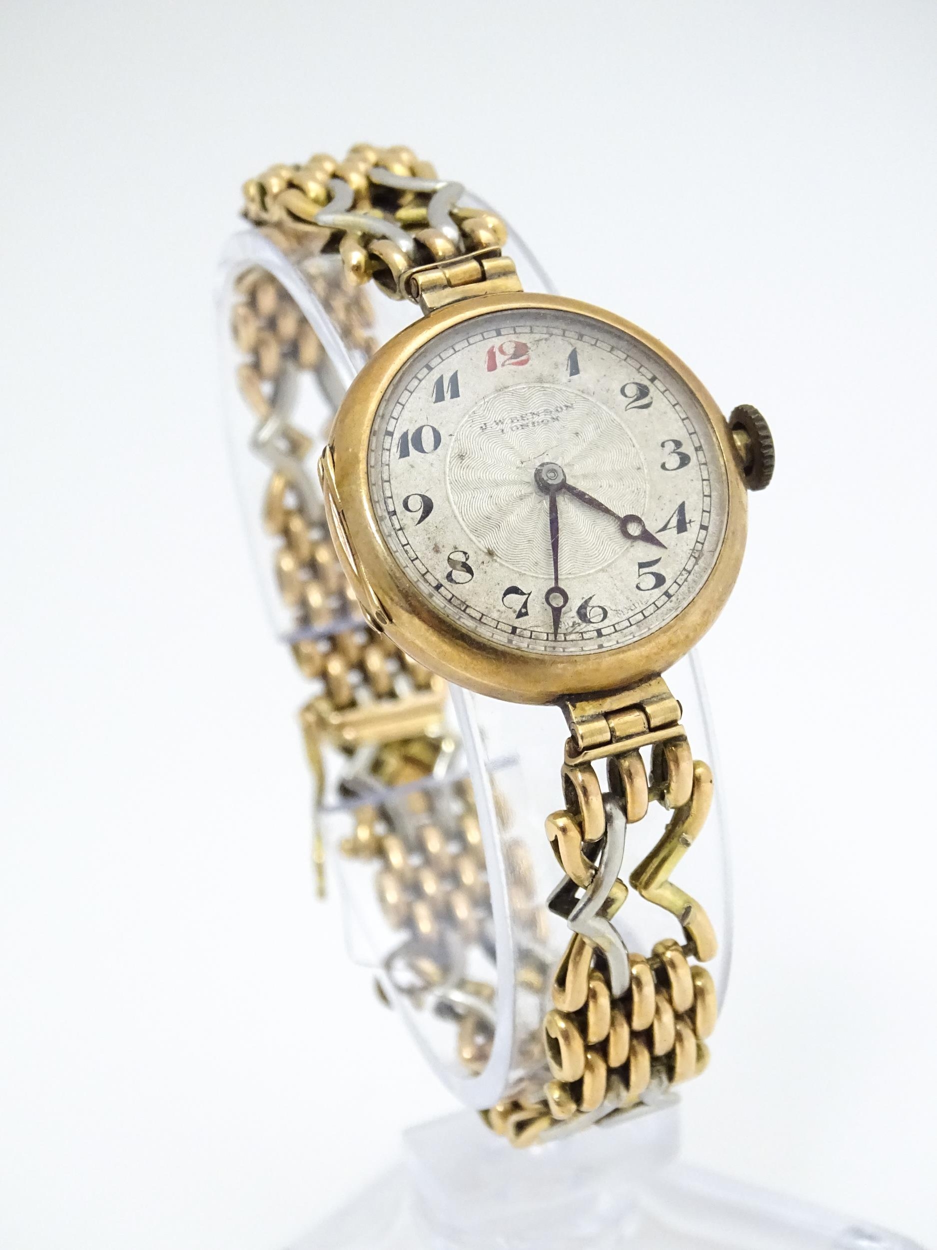 A c.1925 9ct gold cast ladies wristwatch, the dial with engraved decoration, Arabic numerals and