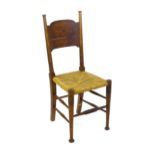 An Arts & Crafts chair designed by William Birch of High Wycombe, with turned tapering uprights