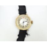A 9ct gold cased ladies wristwatch with black ribbon strap, with fittings marks 14k. The watch