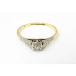 An 18ct gold ring with platinum set diamond. Ring size approx. M Please Note - we do not make