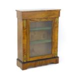 A late 19thC walnut pier cabinet with a rectangular top above a glazed door flanked by brass