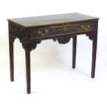 A Victorian carved oak side table with a rectangular top above a carved frieze and single long