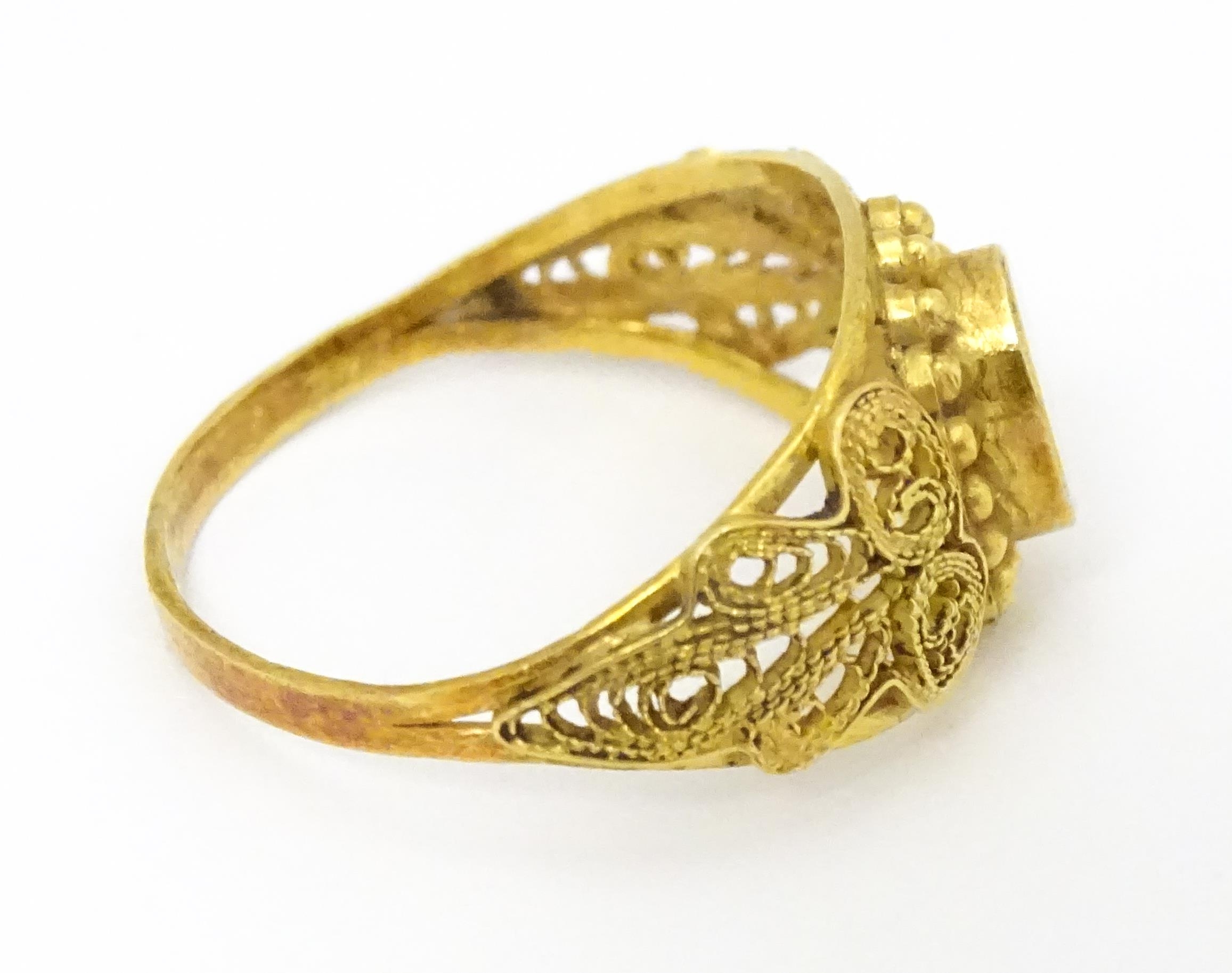 A yellow metal ring with filigree decoration. Ring size approx. K 1/2 Please Note - we do not make - Image 7 of 7