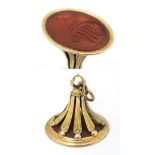 A 19thC gilt metal fob / hand seal set with carnelian with engraved armorial. Approx 1 3/4" high,