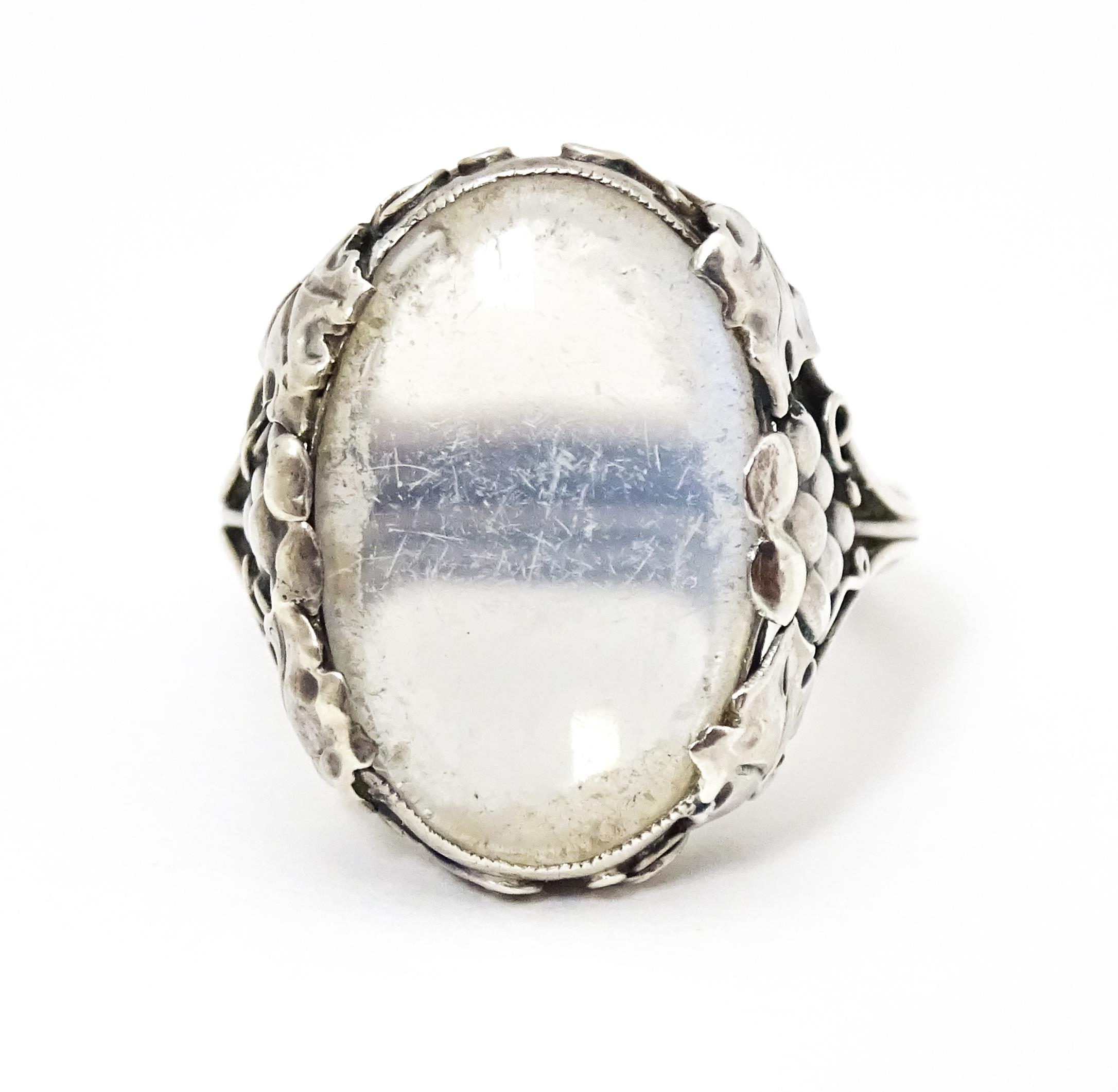 A white metal ring set with central oval moonstone cabochon and with fruiting vine detail to - Image 2 of 6