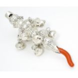 A .925 silver baby's rattle with ten bells and coral branch. Approx 5" long Please Note - we do