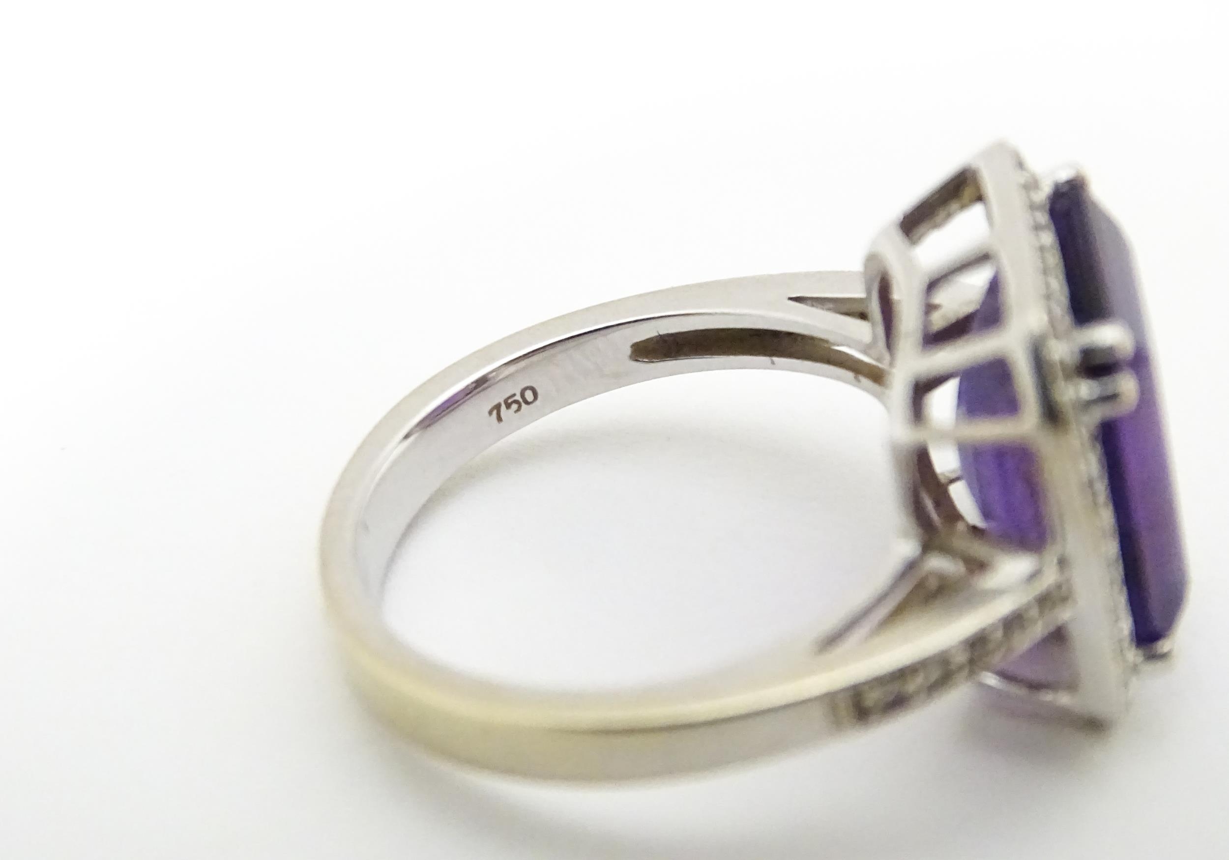 An 18ct gold ring set with central amethyst bordered by diamonds with further diamonds to shoulders. - Image 3 of 8