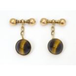 A pair of 9ct gold cufflinks set with tiger's eye Please Note - we do not make reference to the