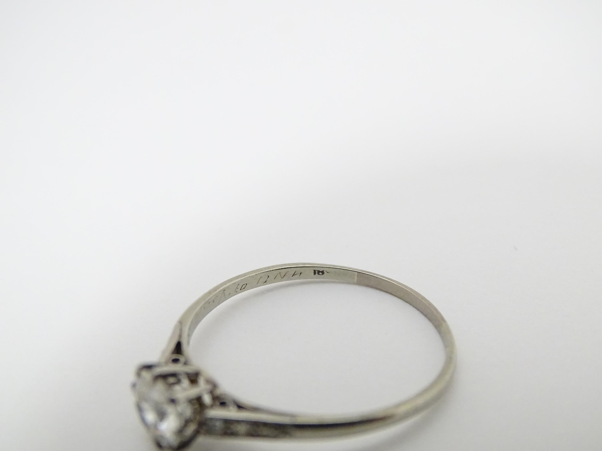 A 18ct white gold ring set with diamond solitaire ring flanked by 3 diamonds to the shoulders. - Image 6 of 7