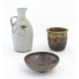 Three items of studio pottery, comprising a jug with loop handle and brushwork decoration, a