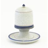 A ceramic table top vesta / match keep of pedestal form with cover with a crackle glaze and banded