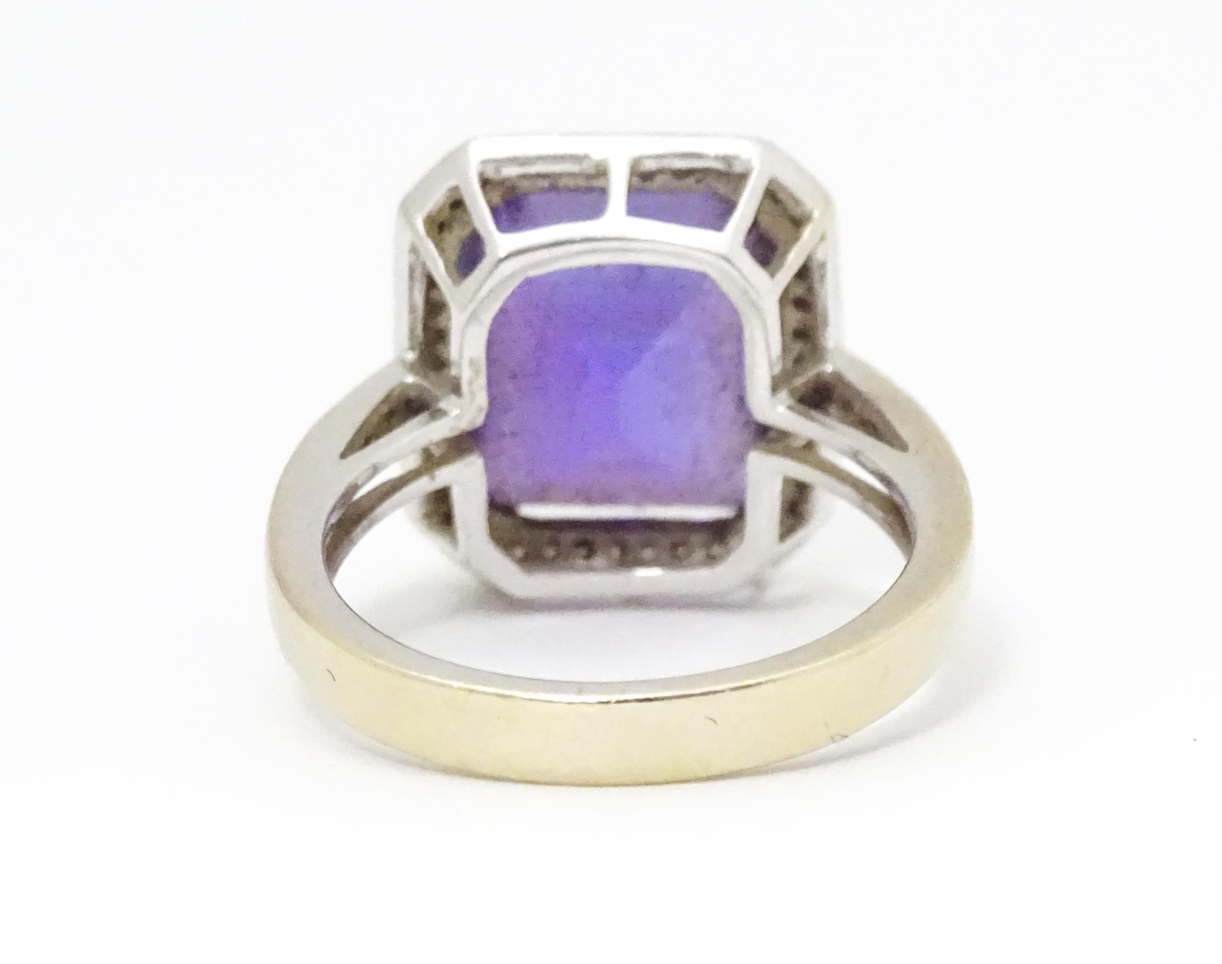 An 18ct gold ring set with central amethyst bordered by diamonds with further diamonds to shoulders. - Image 2 of 8