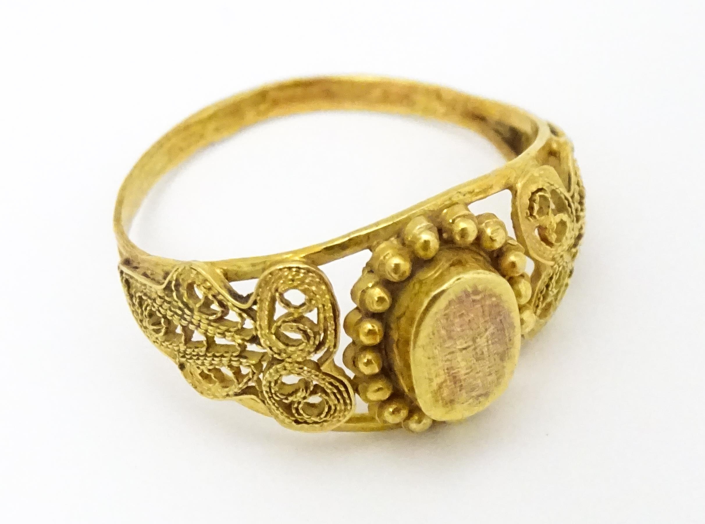 A yellow metal ring with filigree decoration. Ring size approx. K 1/2 Please Note - we do not make - Image 4 of 7