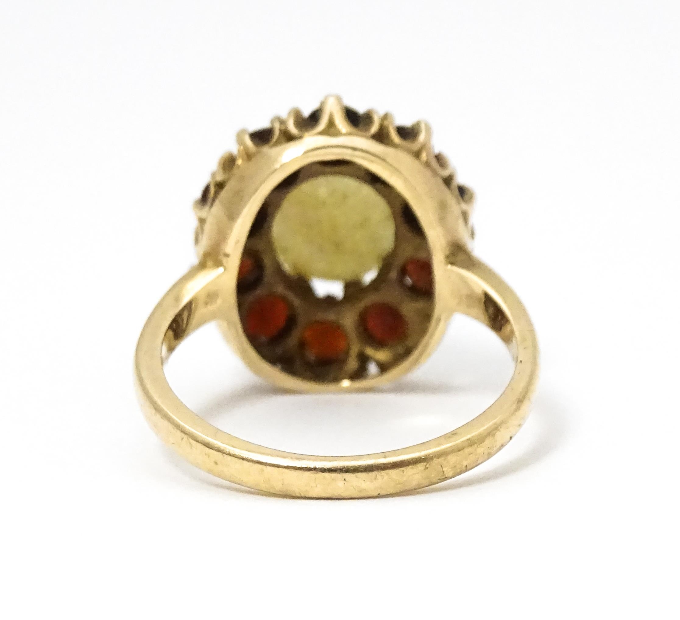 A 9ct gold ring set with central opal bordered by garnets. Ring size approx. L Please Note - we do - Image 4 of 7