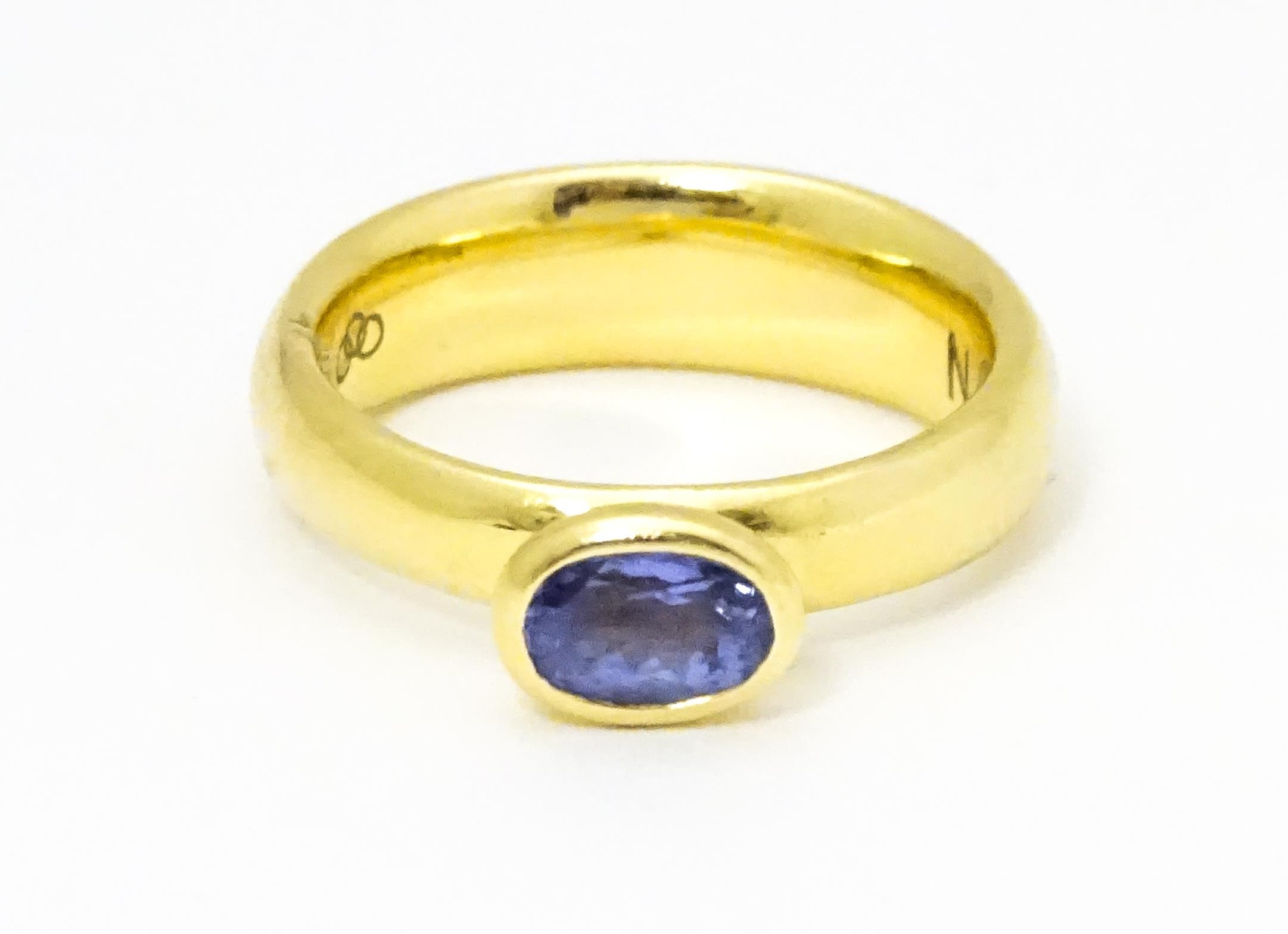 An 18ct gold ring set with oval tanzanite, maker Links of London. Ring size approx M Please Note -