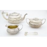 A three piece silver tea set comprising teapot, milk jug and lidded sugar bowl, together with