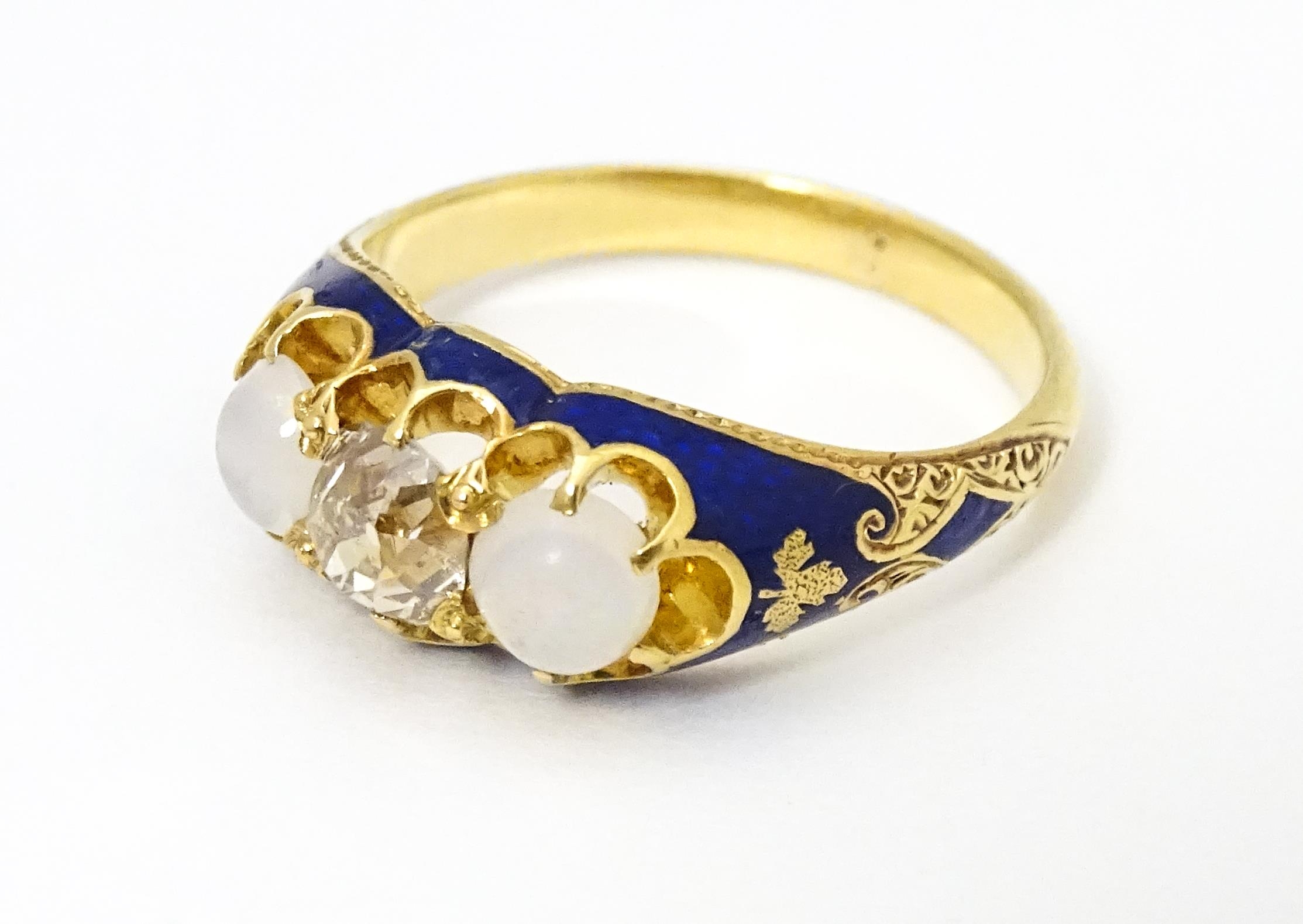 A 19thC yellow gold ring set with central diamond flanked by opals in a blue enamel setting. Ring - Image 3 of 4