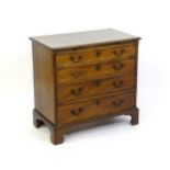 A late Georgian mahogany chest of drawers with a brushing slide above four long drawers with swan