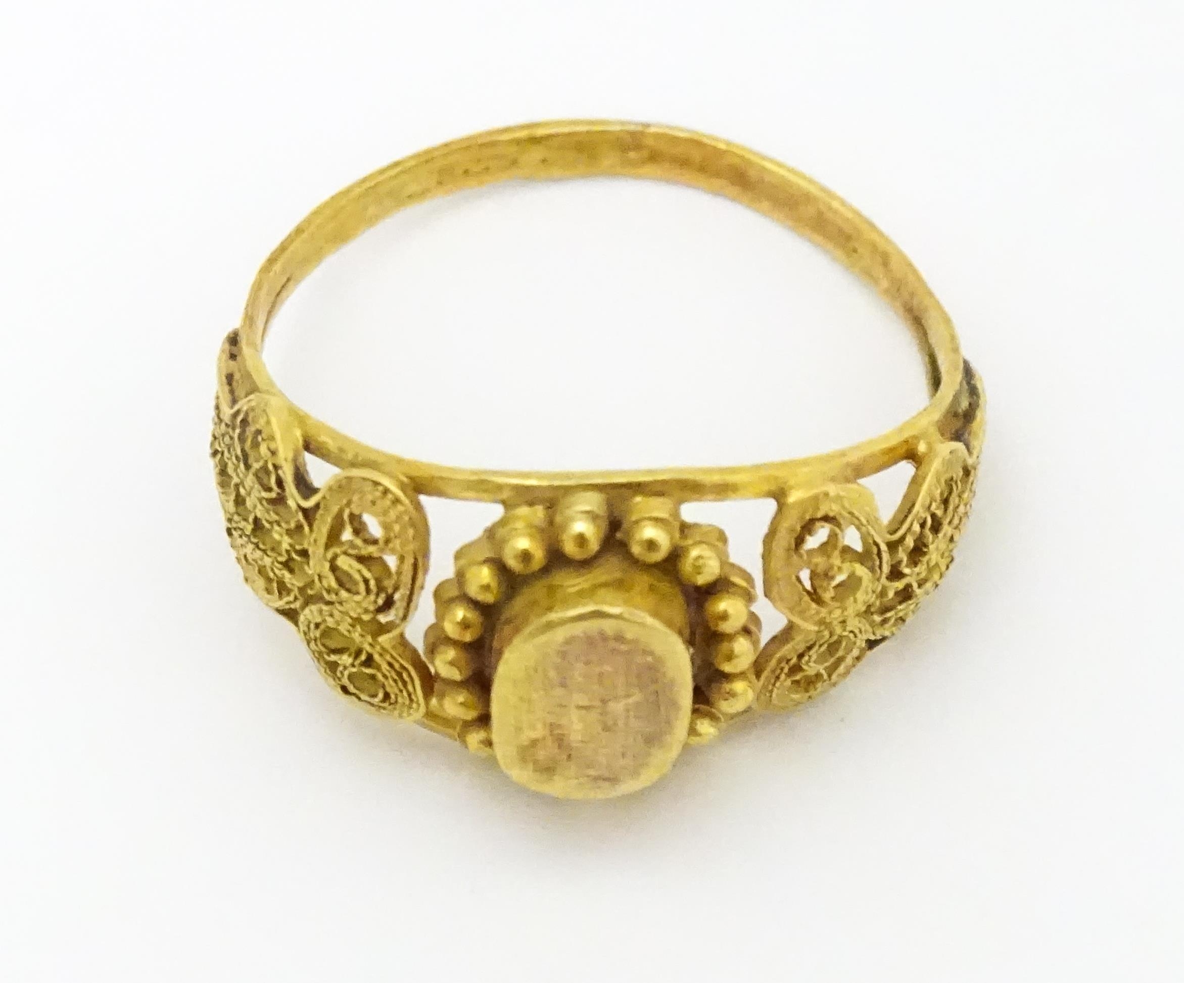 A yellow metal ring with filigree decoration. Ring size approx. K 1/2 Please Note - we do not make - Image 3 of 7