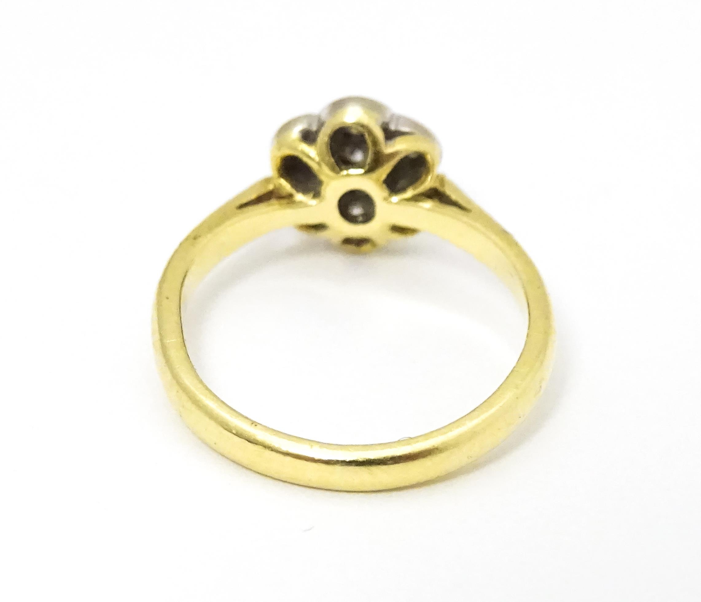 An 18ct gold ring set with 7 diamonds in a daisy setting. Ring size approx. H Please Note - we do - Image 8 of 10