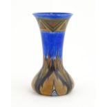 An Art Deco Clews & Co. Chameleon ware vase with flared rim decorated in the Blue Flame pattern.