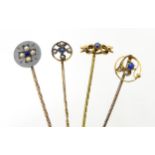 Four various gold and yellow metal stick pins set with blue stones, seed pearls etc two marked