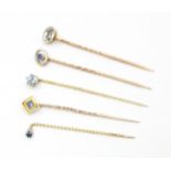 Five assorted gold and yellow metal stick pins set with sapphires, topaz, etc. To include 15ct