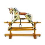 Toy: A late 19th / early 20thC small proportion dapple rocking horse with painted features,