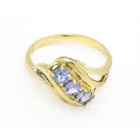 A 9ct gold ring set with three pale lilac iolite. Ring size approx. Please Note - we do not make