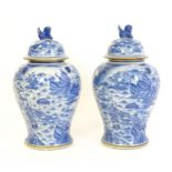 A pair of large Chinese blue and white ginger jars of baluster form with continuous decoration