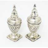 Two silver pepperettes, hallmarked Sheffield 1898 and 1902 maker Fenton Brothers Ltd. Approx 3 1/