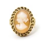 A Continental gold ring set with central shell carved cameo with a filigree mount. Ring size approx.