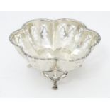 A silver bonbon dish with pierced detail and raised on three out swept feet. Hallmarked Birmingham