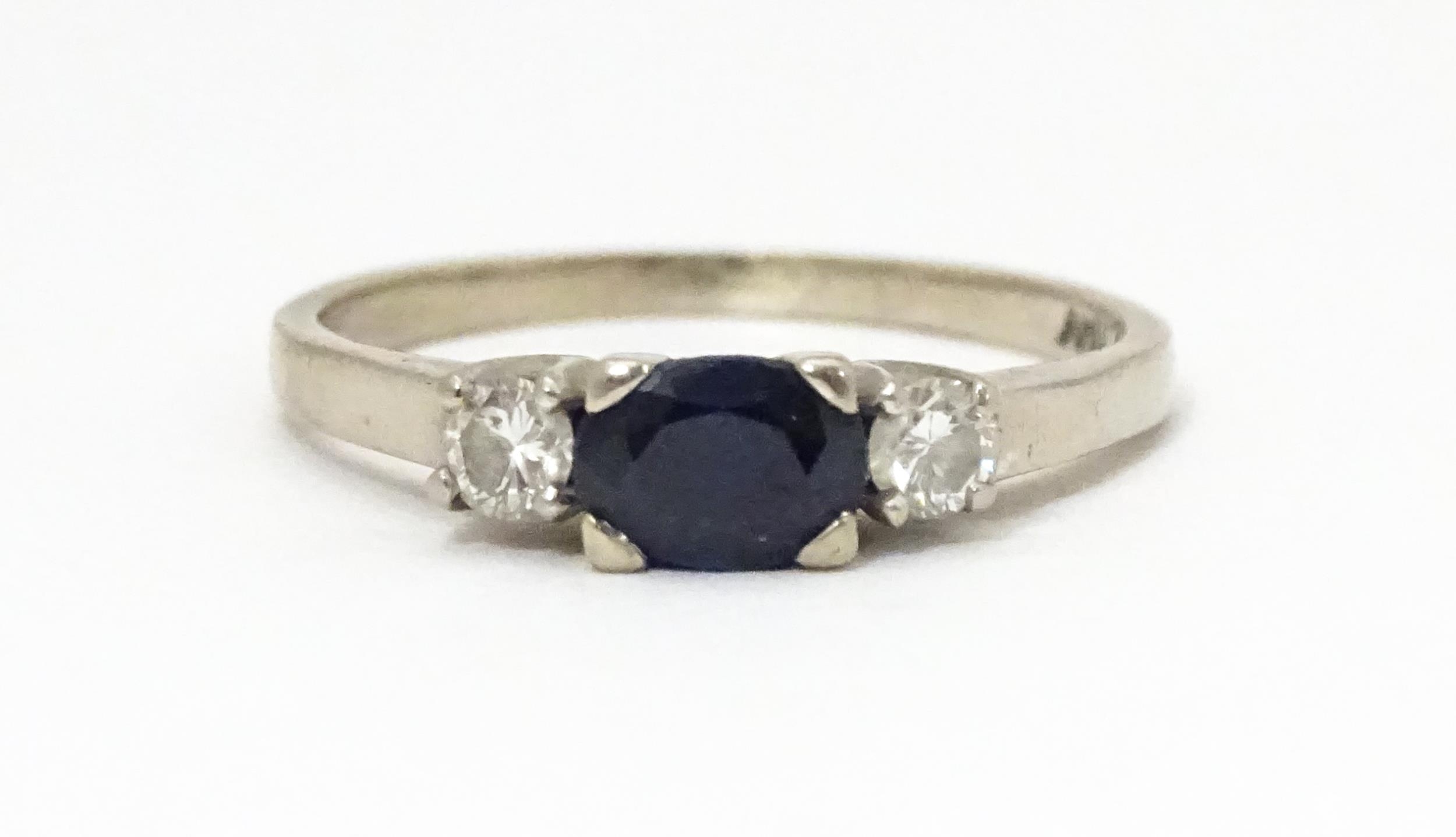 An 18ct white gold ring set with central sapphire flanked by diamonds. Ring size approx. M 1/2 - Image 4 of 6