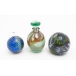 Three items of art glass comprising a Mdina glass paperweight, a scent / perfume bottle and