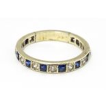 A white metal eternity ring set with blue and white stones. Ring size approx p 1/2 Please Note -
