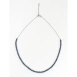 A silver necklace set with blue diamonds Please Note - we do not make reference to the condition