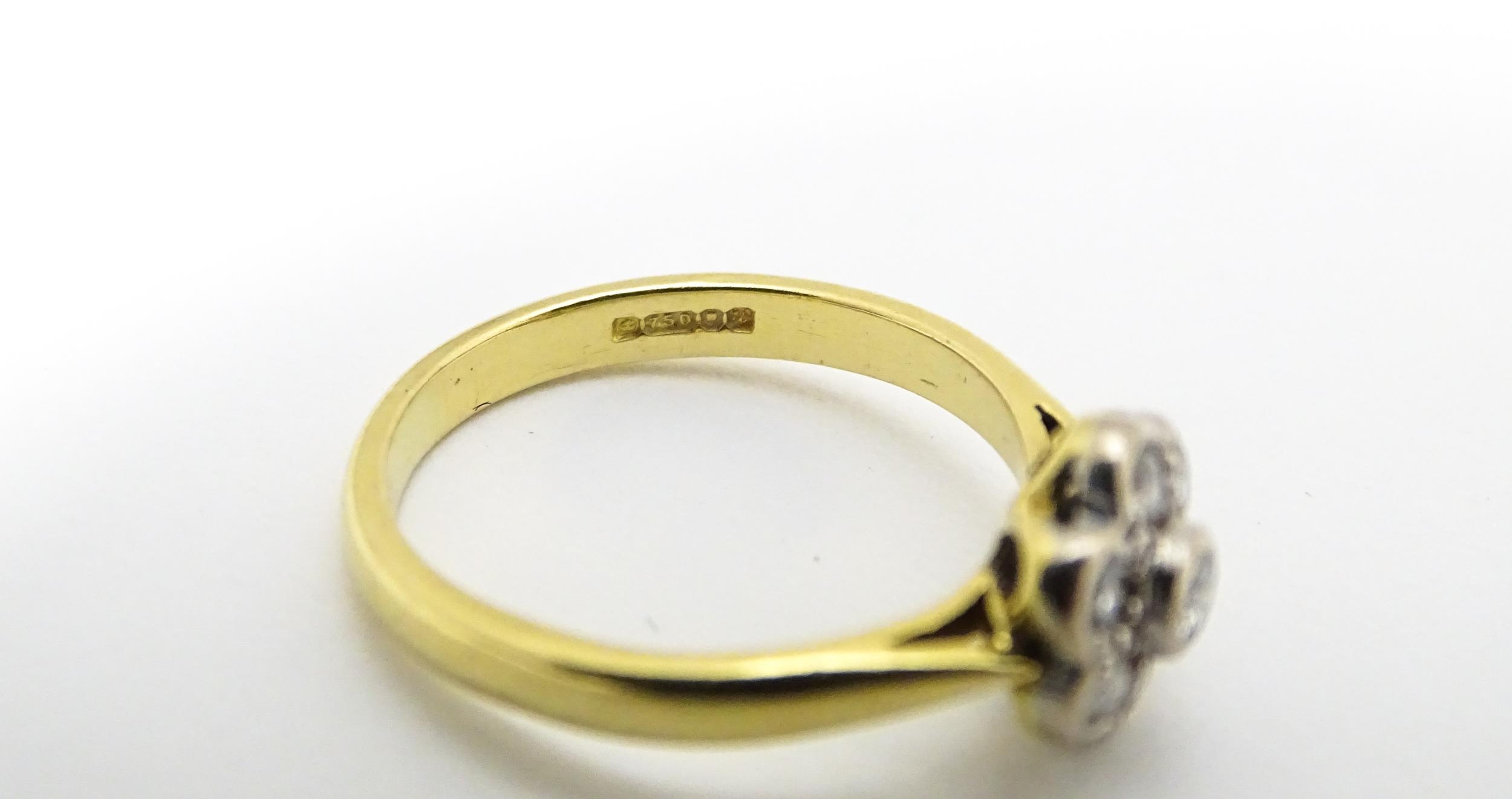 An 18ct gold ring set with 7 diamonds in a daisy setting. Ring size approx. H Please Note - we do - Image 9 of 10