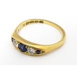 An 18ct gold ring set with sapphires and diamonds and hallmarked Chester 1909 maker B H Joseph &