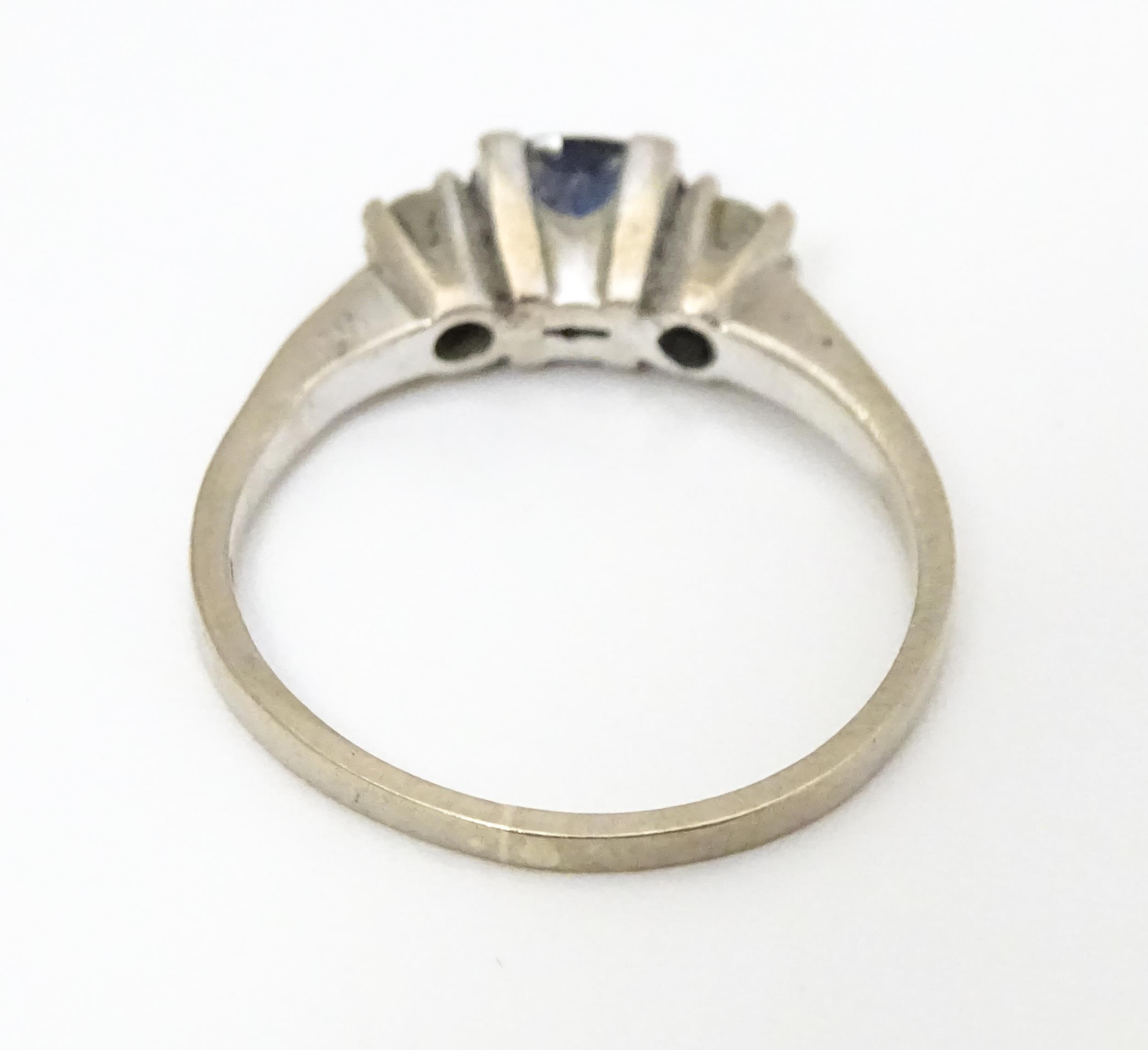 An 18ct white gold ring set with central sapphire flanked by diamonds. Ring size approx. M 1/2 - Image 6 of 6