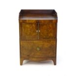 An early 19thC mahogany tray top cabinet with a shaped upstand, pierced hand handles and having