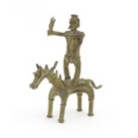 A native tribal cast sculpture modelled as a figure standing on a horse. Approx. 5 3/4" high