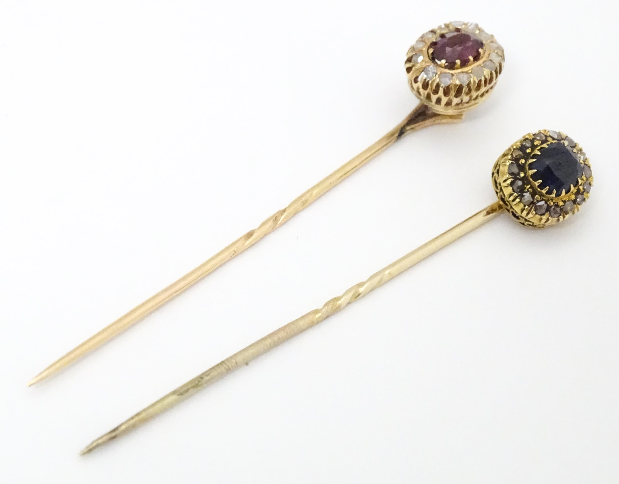 Two yellow metal stick pins, one surmounted by a central sapphire bordered by diamonds, the other - Image 6 of 6