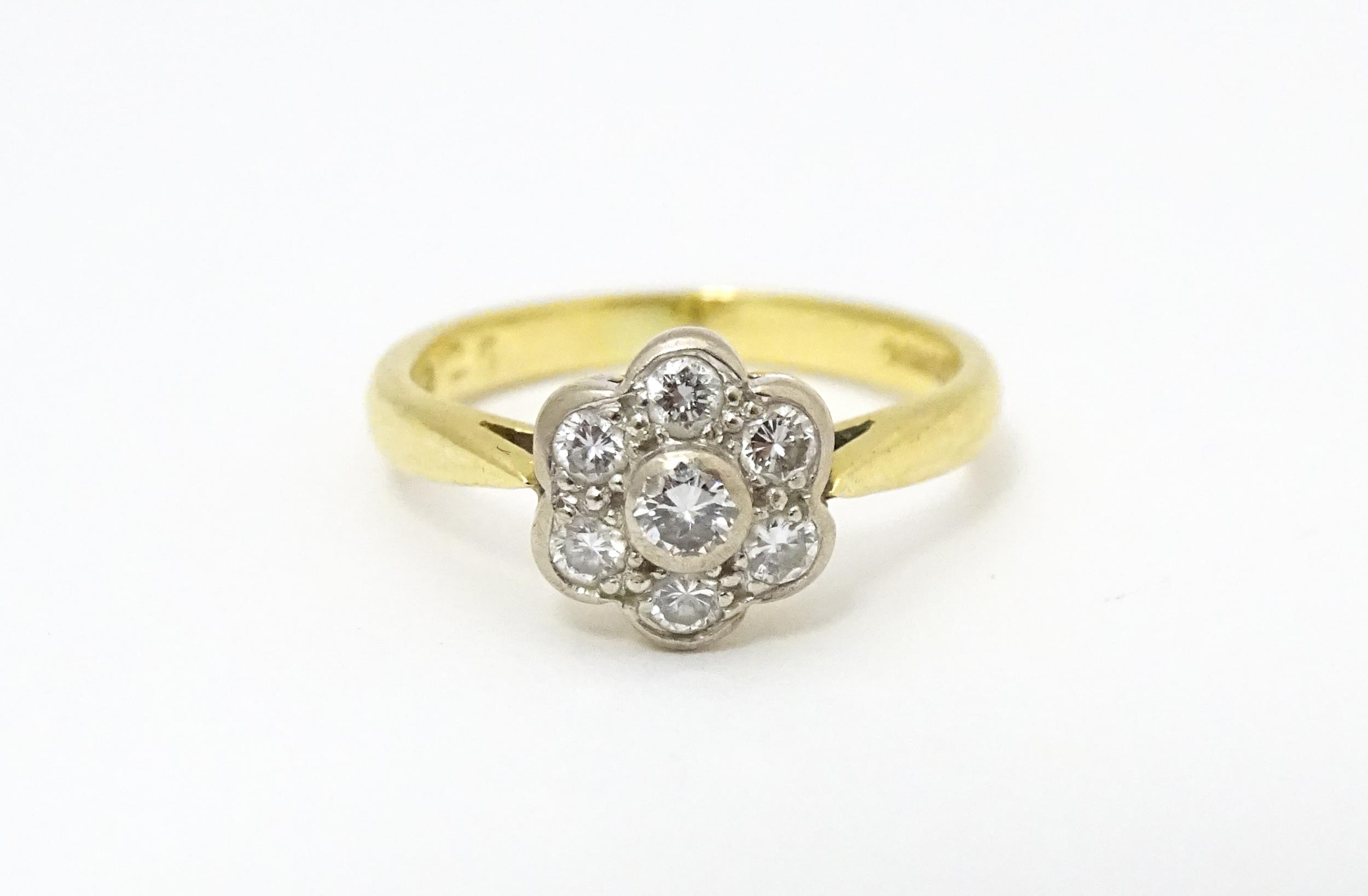 An 18ct gold ring set with 7 diamonds in a daisy setting. Ring size approx. H Please Note - we do - Image 6 of 10