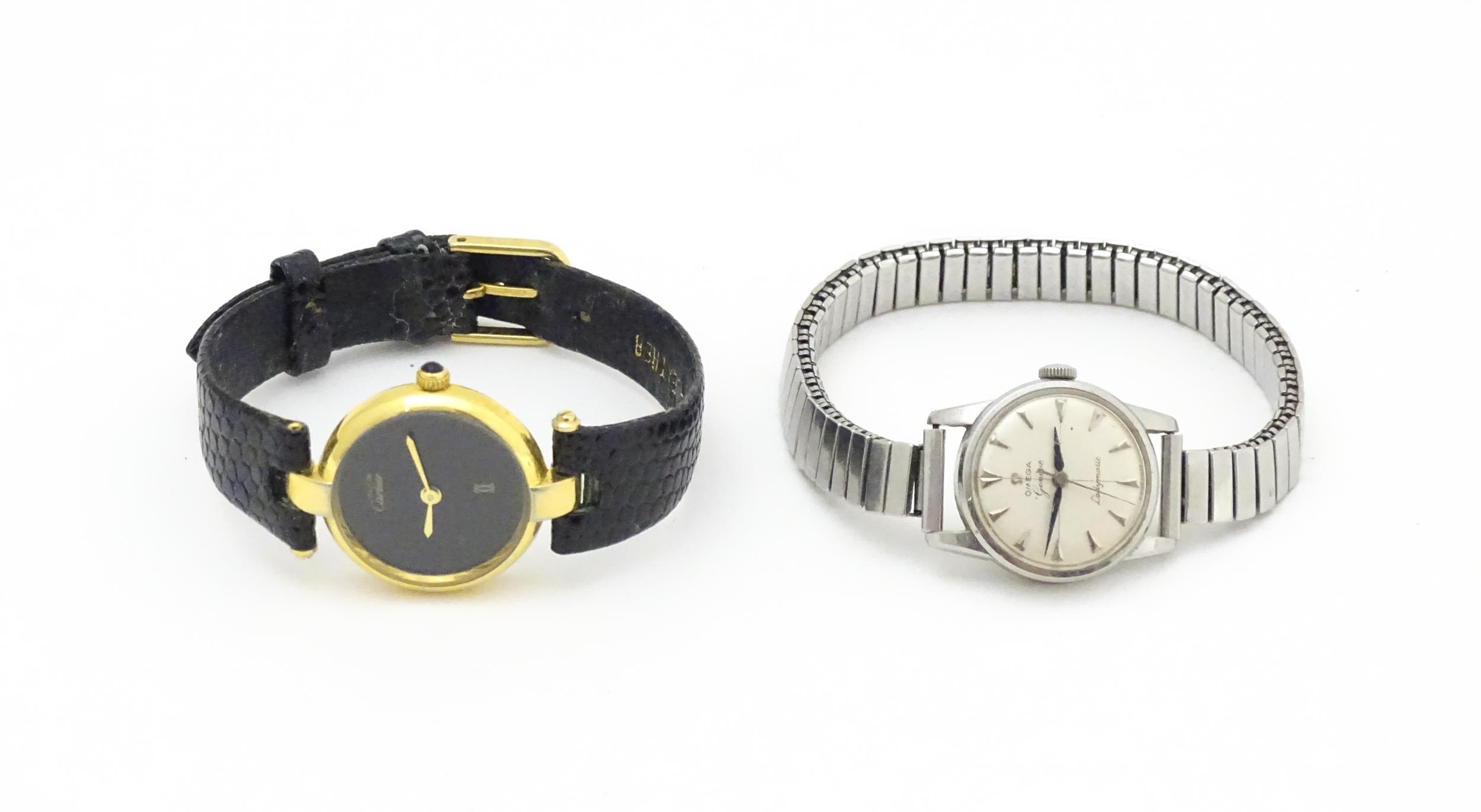 A ladies Omega Ladymatic wristwatch. Together with a quartz wrist watch, the dial signed Must de