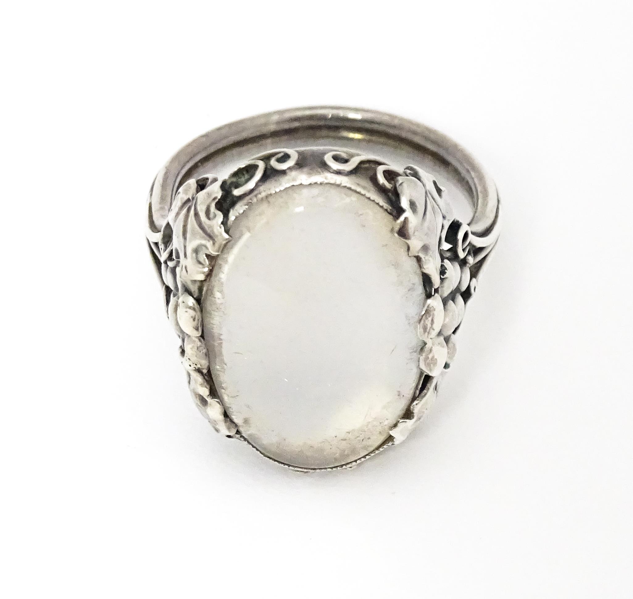 A white metal ring set with central oval moonstone cabochon and with fruiting vine detail to - Image 5 of 6