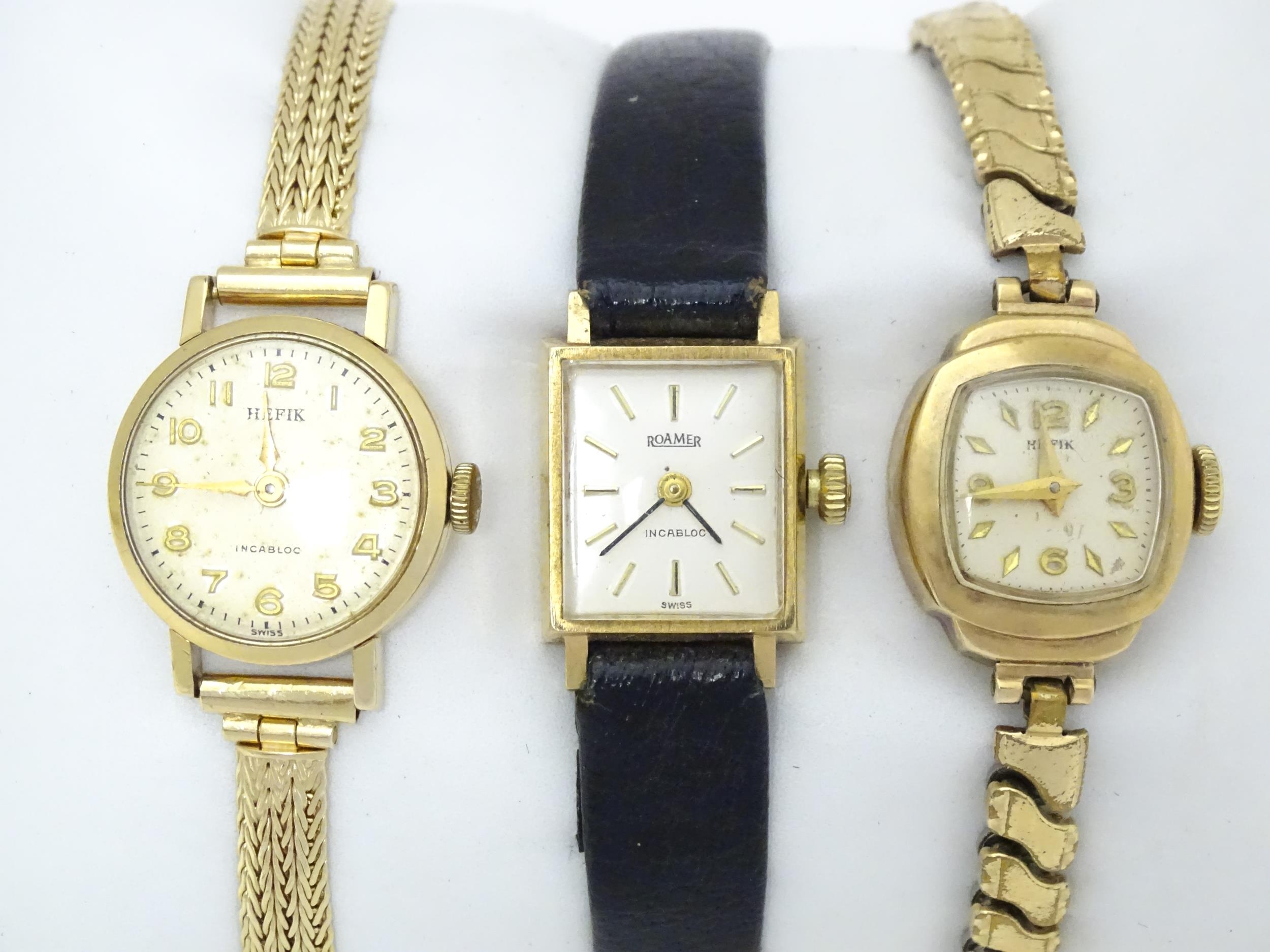 Three 9ct gold cases ladies wristwatches, to include a Hefik wrist watch with 9ct gold strap,