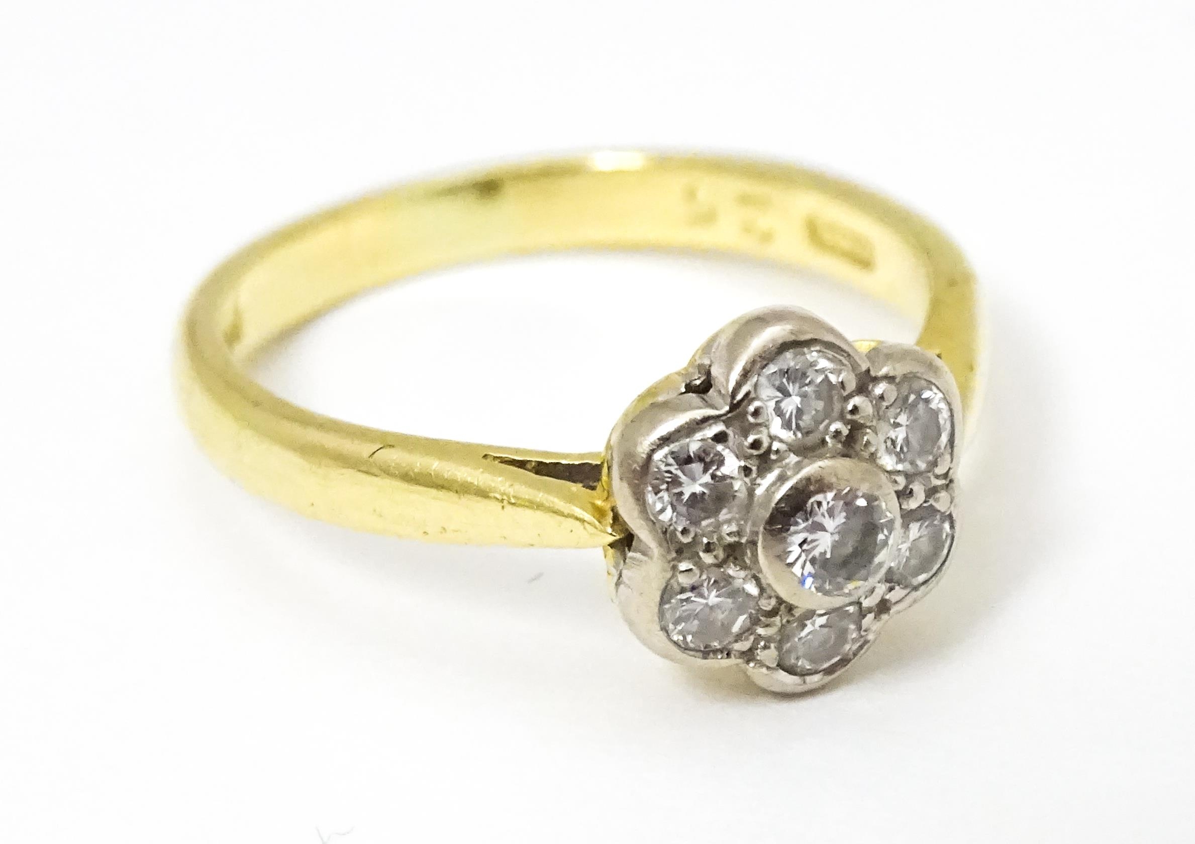 An 18ct gold ring set with 7 diamonds in a daisy setting. Ring size approx. H Please Note - we do - Image 7 of 10